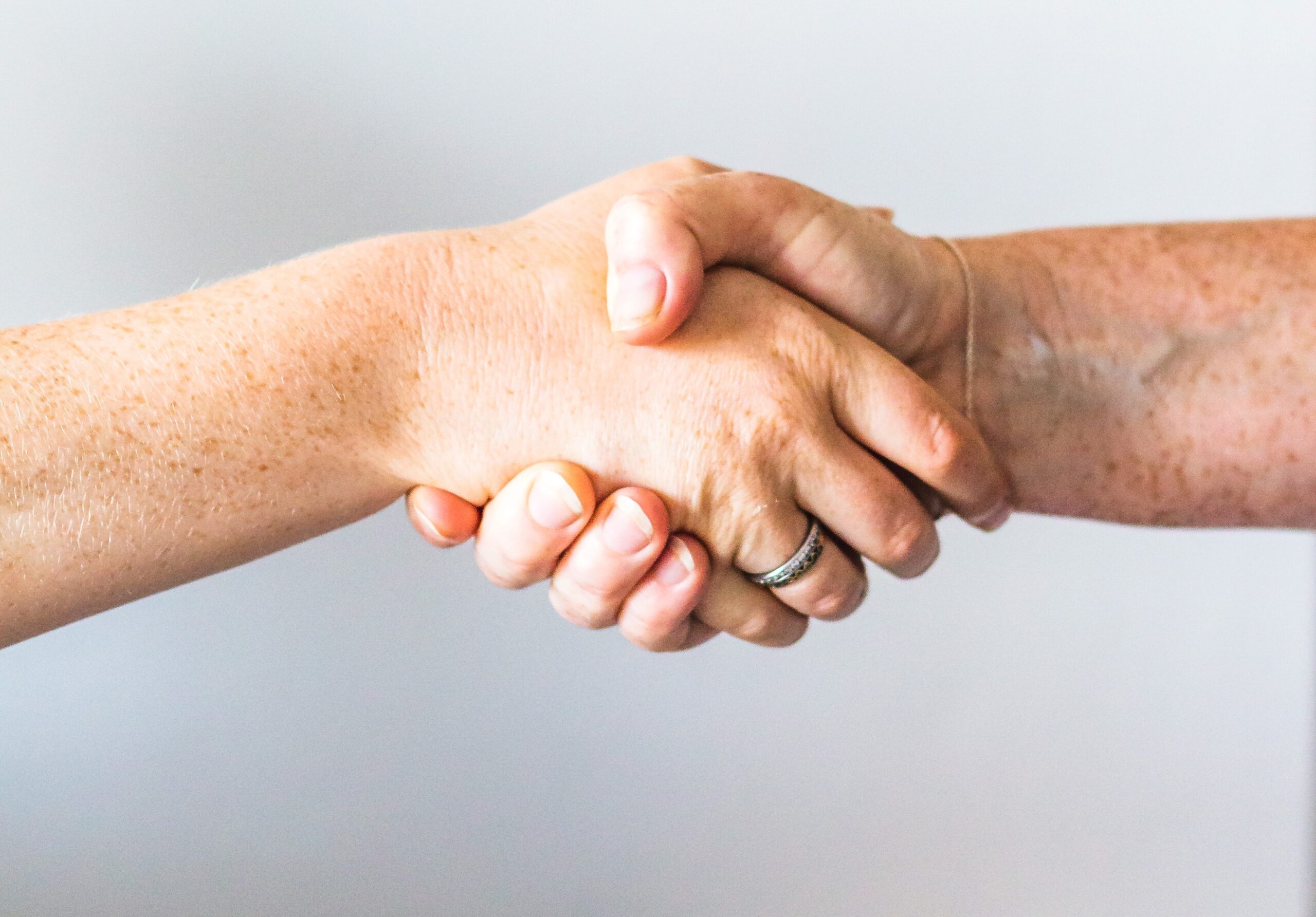 Two people shaking hands to represent a business partnership